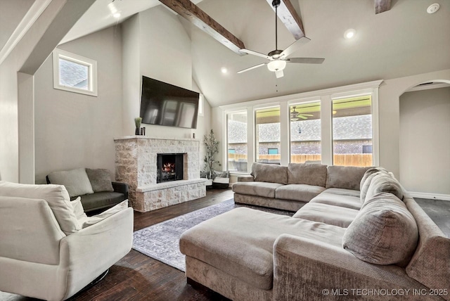 14505 E 79th St, Owasso, OK 74055 - living room with arched walkways, a ceiling fan, dark wood finished floors, beam ceiling, and a fireplace