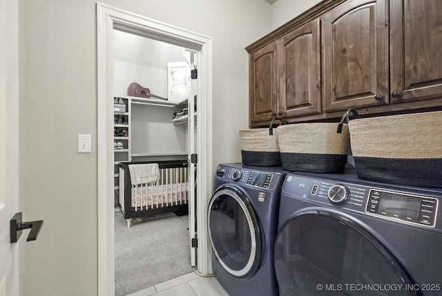 14505 E 79th St, Owasso, OK 74055 - laundry room featuring cabinet space, washing machine and dryer, light carpet, and light tile patterned flooring
