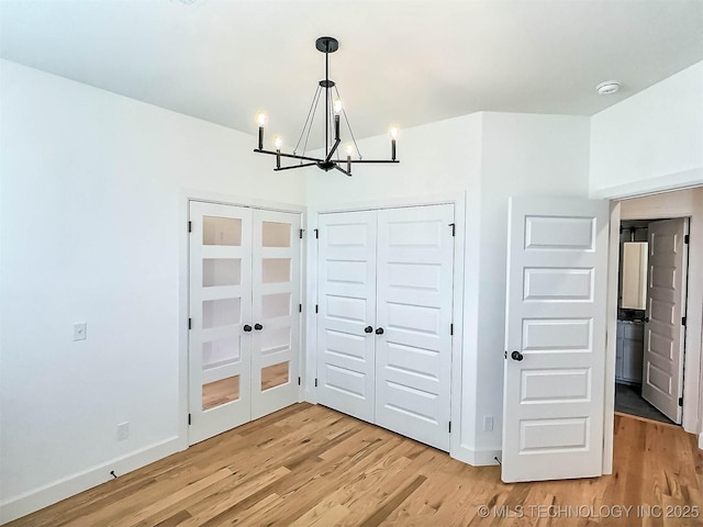 5657 E 141st Pl N, Collinsville, OK 74021 - unfurnished dining area featuring a chandelier and light wood-style floors