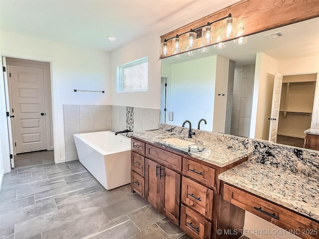5657 E 141st Pl N, Collinsville, OK 74021 - full bathroom with a soaking tub, vanity, and a closet