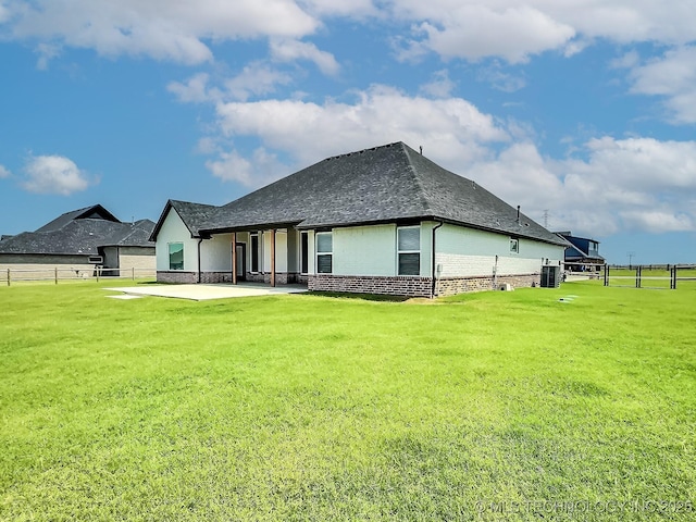 5657 E 141st Pl N, Collinsville, OK 74021 - rear view of house with a patio, brick siding, and roof with shingles