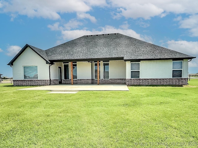 5657 E 141st Pl N, Collinsville, OK 74021 - back of house featuring brick siding, a patio, roof with shingles, and a yard