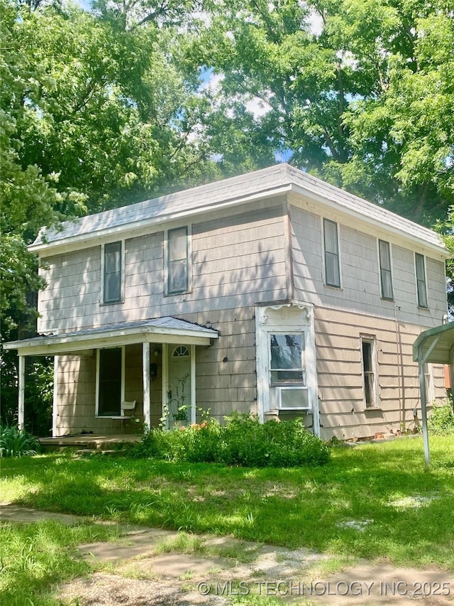 103 S Dunlap St, Cleveland, OK 74020 - colonial-style house featuring a front lawn, a porch, and a carport