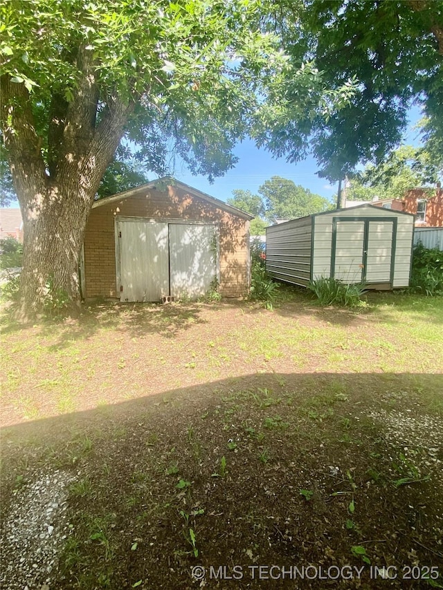 103 S Dunlap St, Cleveland, OK 74020 - view of yard with a storage unit
