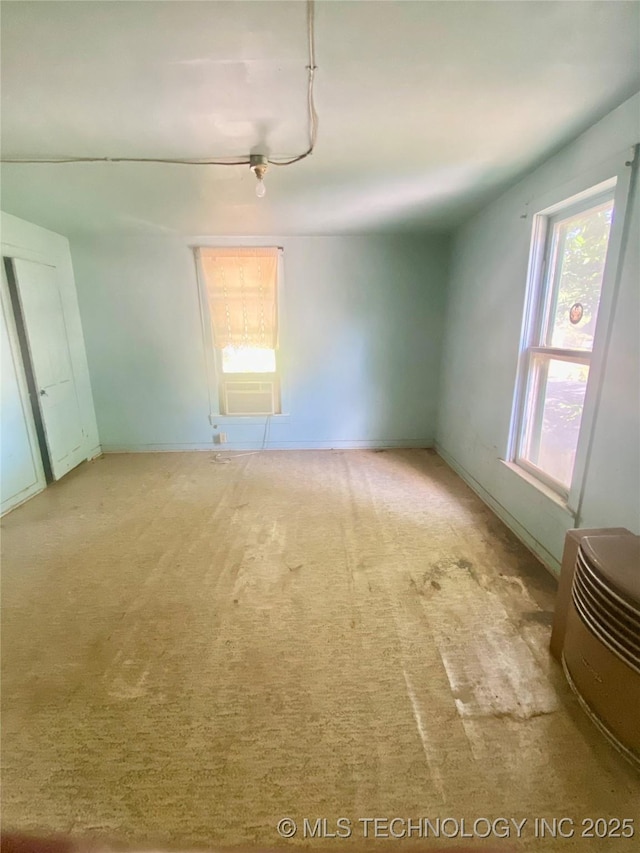 103 S Dunlap St, Cleveland, OK 74020 - unfurnished room with light carpet, ceiling fan, and cooling unit