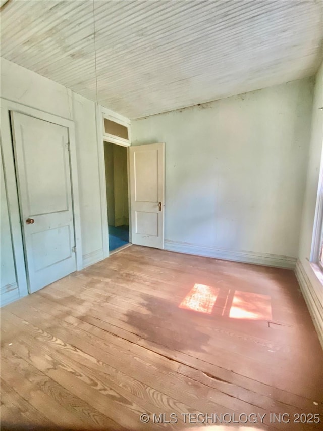103 S Dunlap St, Cleveland, OK 74020 - unfurnished bedroom featuring hardwood / wood-style floors and a closet