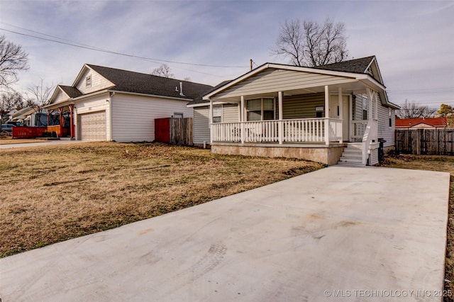 3527 E 4th Pl, Tulsa, OK 74112 - view of front facade with a porch, concrete driveway, an attached garage, and roof with shingles