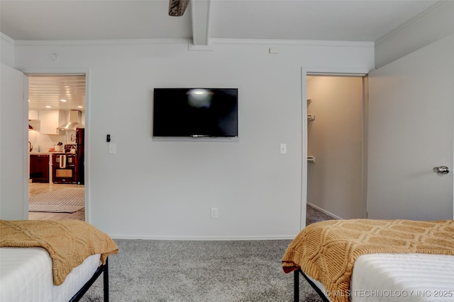 3527 E 4th Pl, Tulsa, OK 74112 - bedroom featuring carpet floors, a walk in closet, crown molding, and beamed ceiling