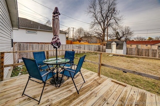 3527 E 4th Pl, Tulsa, OK 74112 - wooden deck with outdoor dining area, a fenced backyard, and a shed