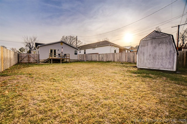 3527 E 4th Pl, Tulsa, OK 74112 - fenced backyard featuring a storage unit and a wooden deck