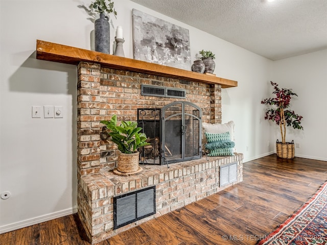 3609 Dana Dr, Bartlesville, OK 74006 - detailed view of a brick fireplace, wood finished floors, and a textured ceiling