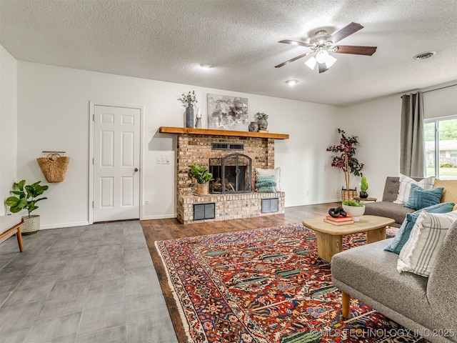 3609 Dana Dr, Bartlesville, OK 74006 - living room with a textured ceiling, a fireplace, a ceiling fan, and wood finished floors