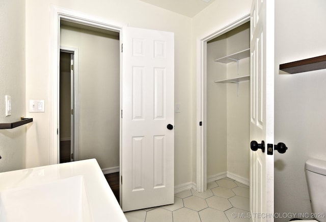 4636 E Independence St, Tulsa, OK 74115 - bathroom with toilet and tile patterned flooring