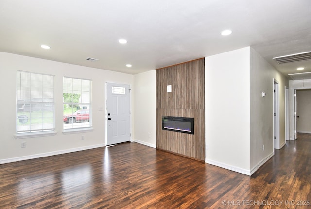 4636 E Independence St, Tulsa, OK 74115 - unfurnished living room with attic access, wood finished floors, recessed lighting, and a large fireplace