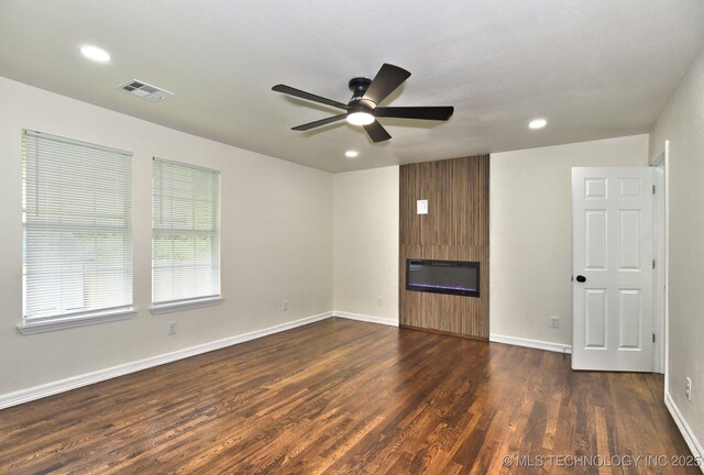 4636 E Independence St, Tulsa, OK 74115 - unfurnished living room featuring ceiling fan, dark wood-style flooring, a large fireplace, and recessed lighting