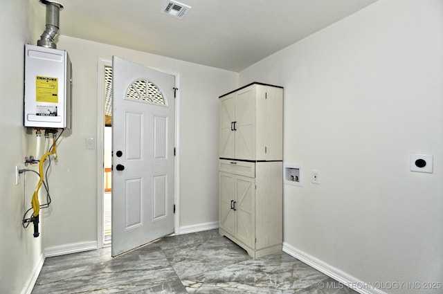 4636 E Independence St, Tulsa, OK 74115 - foyer with baseboards and tankless water heater