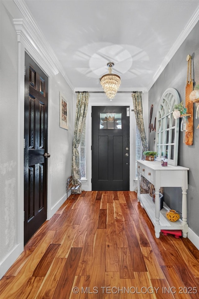 8813 E 104th Pl N, Owasso, OK 74055 - entryway with a chandelier, wood finished floors, and crown molding