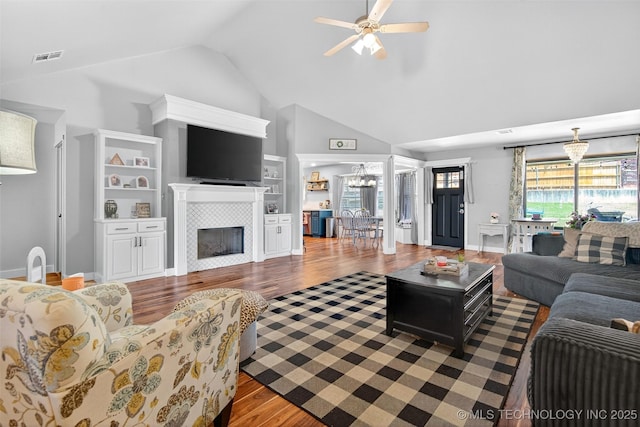 8813 E 104th Pl N, Owasso, OK 74055 - living room with a chandelier, wood finished floors, high vaulted ceiling, a ceiling fan, and a fireplace