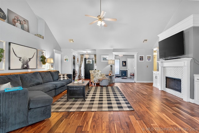 8813 E 104th Pl N, Owasso, OK 74055 - living room with a ceiling fan, high vaulted ceiling, wood finished floors, and a tile fireplace