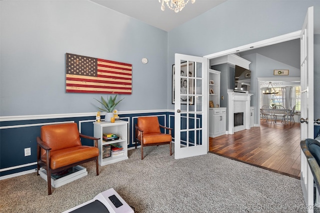 8813 E 104th Pl N, Owasso, OK 74055 - sitting room with a chandelier, high vaulted ceiling, carpet flooring, and a fireplace