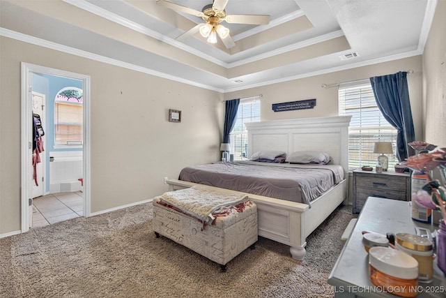 8813 E 104th Pl N, Owasso, OK 74055 - carpeted bedroom with ornamental molding, a tray ceiling, ensuite bathroom, and a ceiling fan