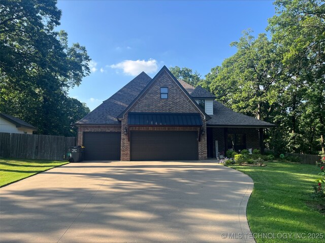239 E 117th St S, Jenks, OK 74037 - view of front facade with a garage, a shingled roof, brick siding, and driveway