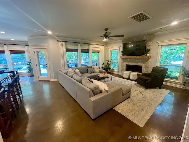 239 E 117th St S, Jenks, OK 74037 - living area featuring finished concrete flooring, ornamental molding, ceiling fan, a stone fireplace, and recessed lighting