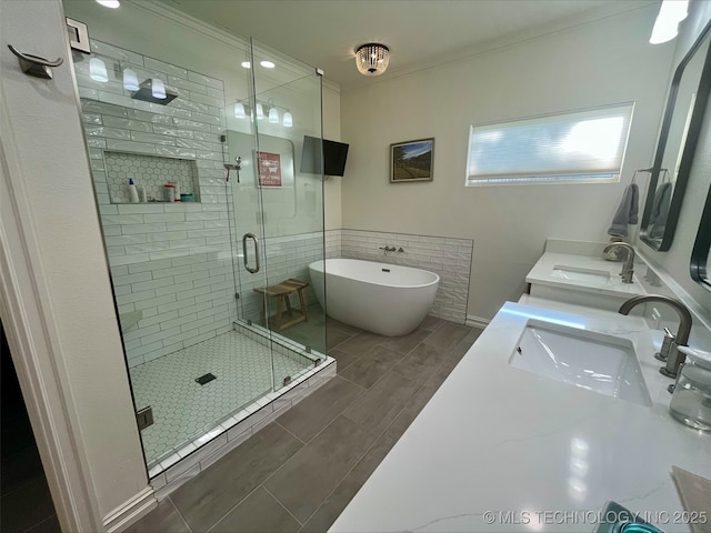 239 E 117th St S, Jenks, OK 74037 - bathroom with a stall shower, a freestanding bath, ornamental molding, double vanity, and wood tiled floors