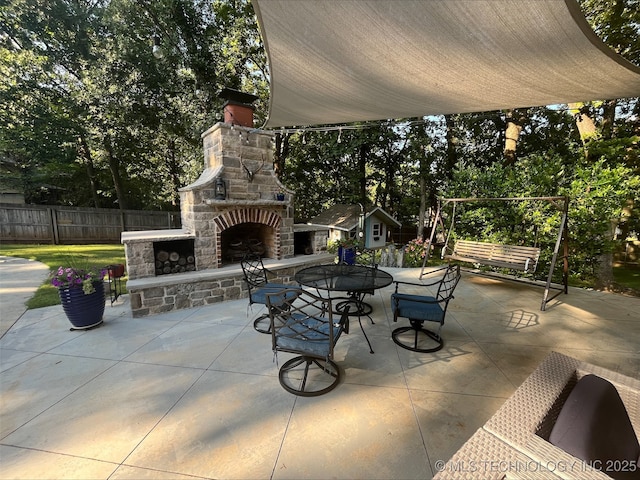 239 E 117th St S, Jenks, OK 74037 - fenced backyard with a patio, an outdoor stone fireplace, and view of scattered trees