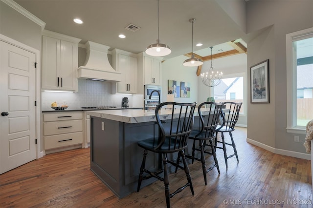 5312 E 124th Pl S, Bixby, OK 74008 - kitchen with custom range hood, dark wood finished floors, backsplash, white cabinetry, and recessed lighting