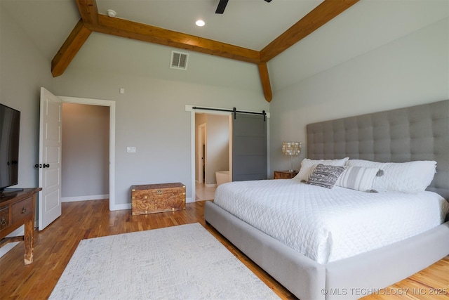 5312 E 124th Pl S, Bixby, OK 74008 - bedroom featuring beam ceiling, a barn door, wood finished floors, high vaulted ceiling, and a ceiling fan