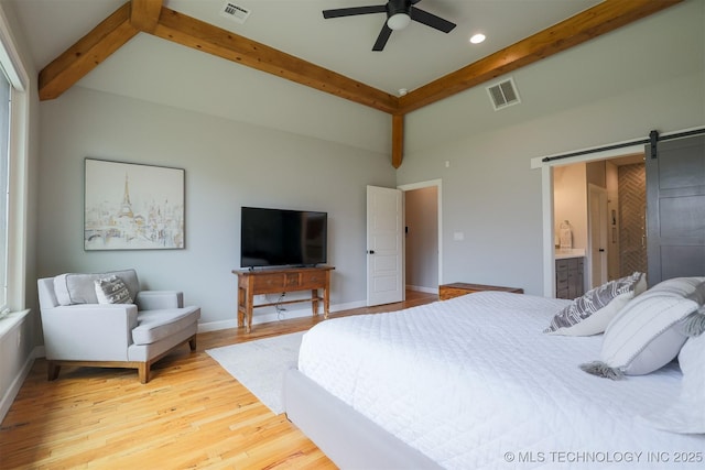 5312 E 124th Pl S, Bixby, OK 74008 - bedroom with beam ceiling, a barn door, wood finished floors, ensuite bath, and recessed lighting