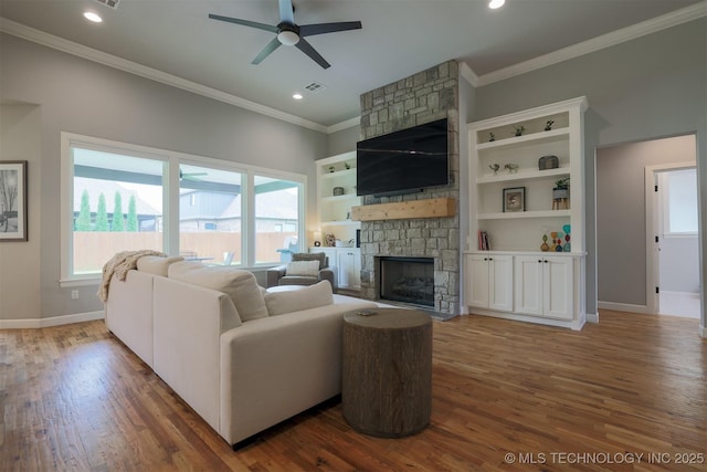 5312 E 124th Pl S, Bixby, OK 74008 - living room with a stone fireplace, a ceiling fan, ornamental molding, wood finished floors, and recessed lighting