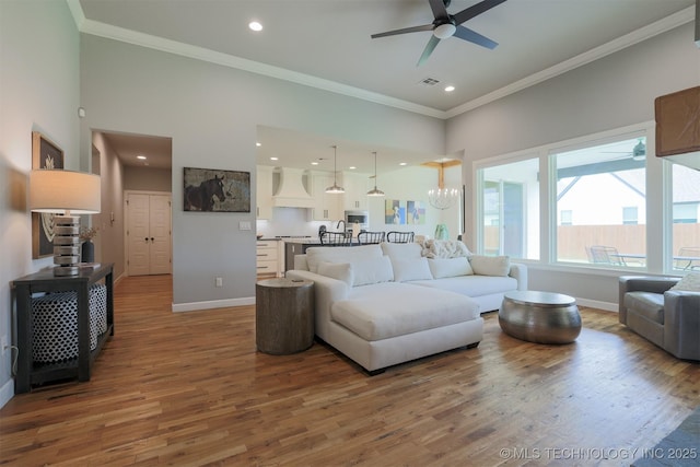 5312 E 124th Pl S, Bixby, OK 74008 - living room featuring a ceiling fan, ornamental molding, wood finished floors, recessed lighting, and a towering ceiling