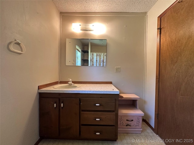 109948 S 4155, Checotah, OK 74426 - bathroom with vanity, a textured ceiling, and tile patterned floors