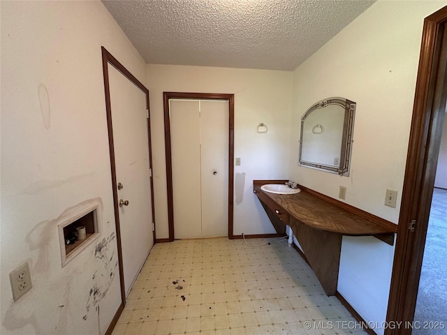 109948 S 4155, Checotah, OK 74426 - laundry room with light floors and a textured ceiling