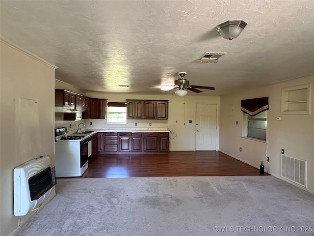 109948 S 4155, Checotah, OK 74426 - kitchen with white gas range oven, dark carpet, heating unit, a textured ceiling, and a ceiling fan