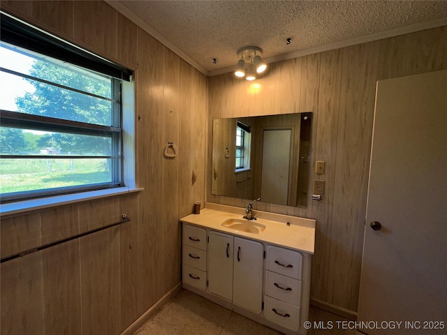 109948 S 4155, Checotah, OK 74426 - bathroom with ornamental molding, wood walls, vanity, and a textured ceiling