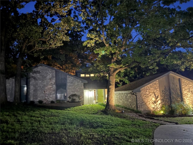 2501 Cherokee Hills Pl, Bartlesville, OK 74006 - view of property exterior featuring stone siding and a lawn
