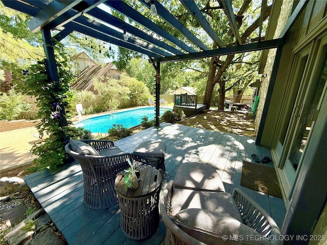 2501 Cherokee Hills Pl, Bartlesville, OK 74006 - fenced backyard featuring a deck, a pergola, and an outdoor pool