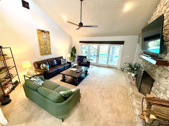 2501 Cherokee Hills Pl, Bartlesville, OK 74006 - living area with carpet flooring, a stone fireplace, ceiling fan, a textured ceiling, and high vaulted ceiling