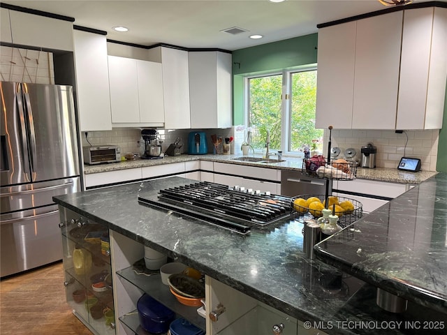 2501 Cherokee Hills Pl, Bartlesville, OK 74006 - kitchen featuring appliances with stainless steel finishes, backsplash, dark stone countertops, and recessed lighting