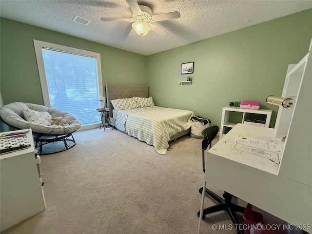2501 Cherokee Hills Pl, Bartlesville, OK 74006 - bedroom featuring a textured ceiling, carpet flooring, and ceiling fan