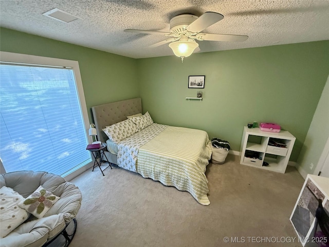 2501 Cherokee Hills Pl, Bartlesville, OK 74006 - bedroom with carpet, a ceiling fan, and a textured ceiling