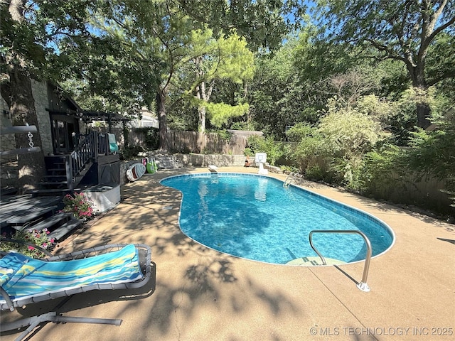 2501 Cherokee Hills Pl, Bartlesville, OK 74006 - view of pool with a fenced backyard, a patio area, stairs, and view of scattered trees