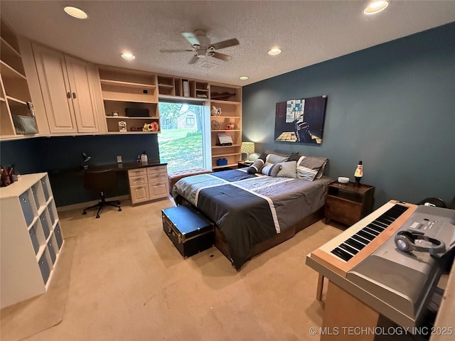 2501 Cherokee Hills Pl, Bartlesville, OK 74006 - bedroom with light colored carpet, built in desk, recessed lighting, and a textured ceiling