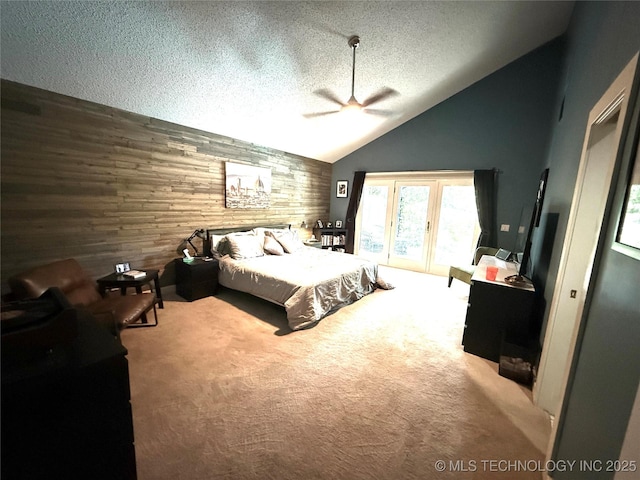 2501 Cherokee Hills Pl, Bartlesville, OK 74006 - carpeted bedroom with access to exterior, a textured ceiling, vaulted ceiling, wood walls, and a ceiling fan