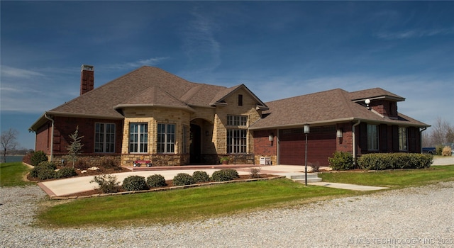 609 Lakeshore Dr, Durant, OK 74701 - french country style house with a chimney, a garage, concrete driveway, roof with shingles, and a front lawn