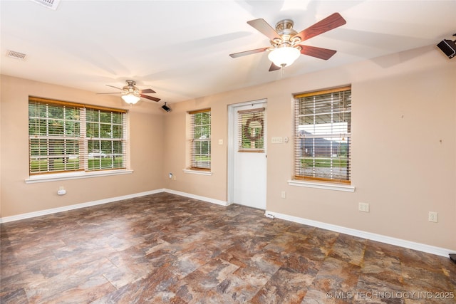 609 Lakeshore Dr, Durant, OK 74701 - spare room featuring a ceiling fan and stone finish flooring