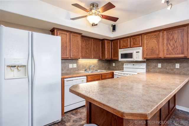 609 Lakeshore Dr, Durant, OK 74701 - kitchen featuring white appliances, light countertops, and brown cabinetry